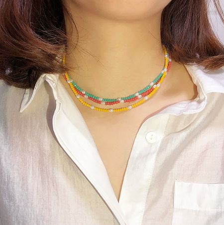 Multi Coloured Beaded Necklace - A woman wearing the vibrant multi-coloured beaded necklace with gold plating, showcasing its fun and stylish design as part of a summer outfit.