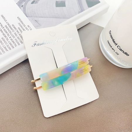 A vibrant, multicolored acetate hair clip displayed as a statement fashion accessory.