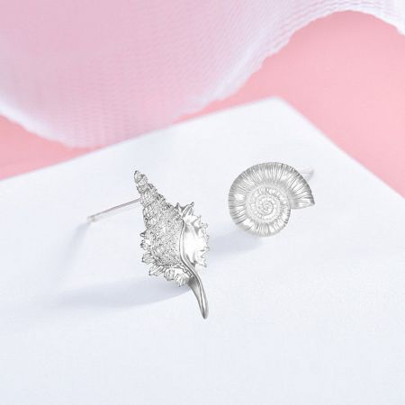 925 Sterling Silver Asymmetrical Sea Shell Conch Stud Earrings (5 Pairs) - A set of five pairs of 925 sterling silver asymmetrical sea shell and conch stud earrings displayed on a pink and white background.