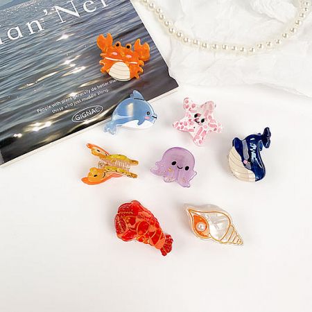 A vibrant set of cute sea animal hair clips, including jellyfish, shell, dolphin, and whale designs.
