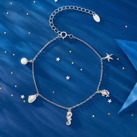 Close-up of the silver ocean charm bracelet with intricate sea-themed charms.