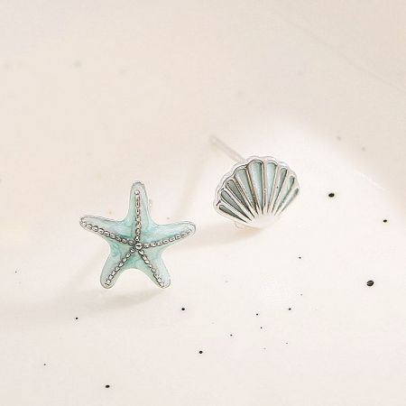 Close-up of the silver-plated enamel starfish and seashell earrings.