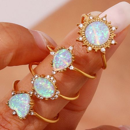 A collection of adjustable 18K gold-plated opal rings with sparkling zircon accents.