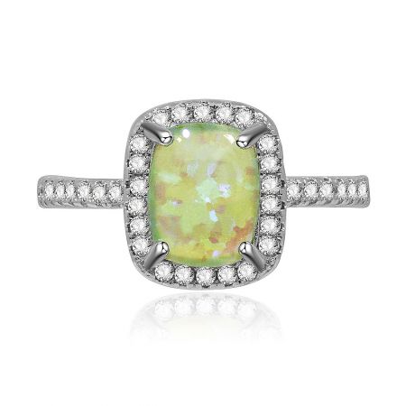 Green Opal Burst White Ring - A close-up of the Green Opal Burst White Ring, showcasing the square-cut green opal glass surrounded by a halo of sparkling white cubic zirconia, set on a rhodium-plated brass band.