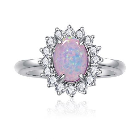 Pink Opal Burst White Ring - A close-up of the Pink Opal Burst White Ring, showcasing the central pink opal glass stone surrounded by a halo of sparkling white cubic zirconia on a rhodium-plated brass band.