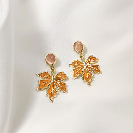 14k Gold Plated Enamel Maple with Glass Stone Drop Earrings (5 pairs) - A pair of 14k gold-plated drop earrings featuring an orange enamel maple leaf design and a delicate pink glass stone.