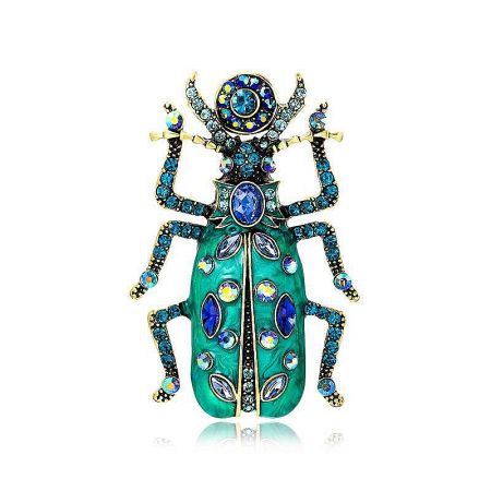 Ornate green and blue beetle brooch, highlighting the intricate metalwork and sparkling gems.