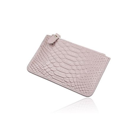 Close-up of a pale pink croc-textured coin purse with a gold snap fastener.
