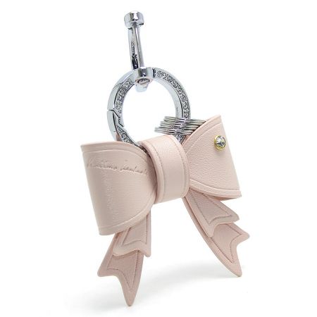 Delicate pale pink PU leather bow keychain with an elegant rhinestone detail.