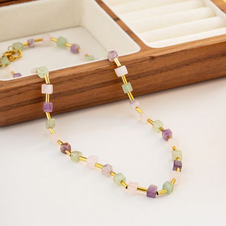 Detailed shot of the multicolor natural stone beads on the gold-tone stainless steel chain.