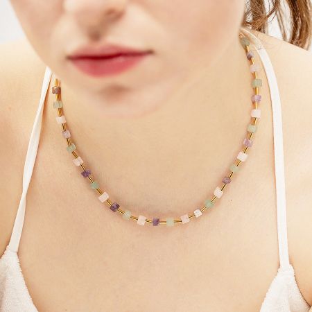 A woman wearing the pastel beaded necklace, highlighting its delicate and fashionable look.