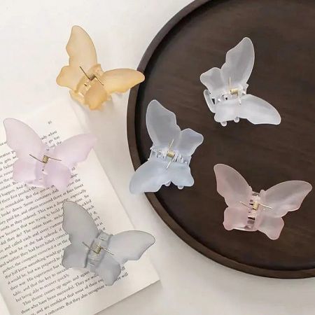 A collection of butterfly hair clips in soft pastel colors.