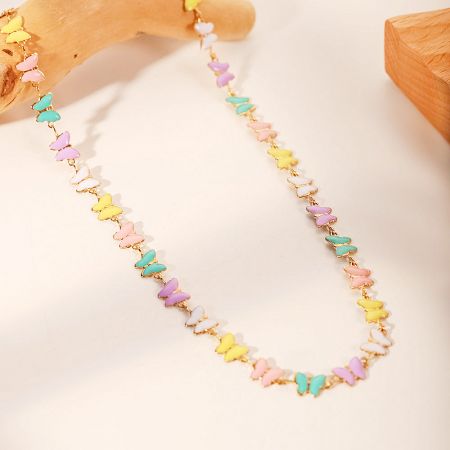 Flat lay view of the pastel-colored butterfly bead necklace.