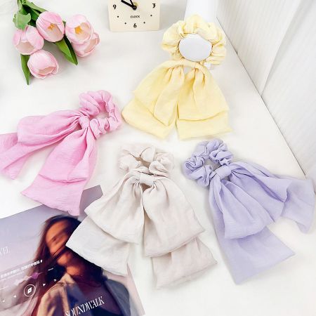 Elastic Ribbon-Knot Hairbands & Scrunchies (Set of 5) - A vibrant arrangement of elastic ribbon-knot hairbands in pastel shades of purple, yellow, pink, and white, showcasing the set of 5 scrunchies.