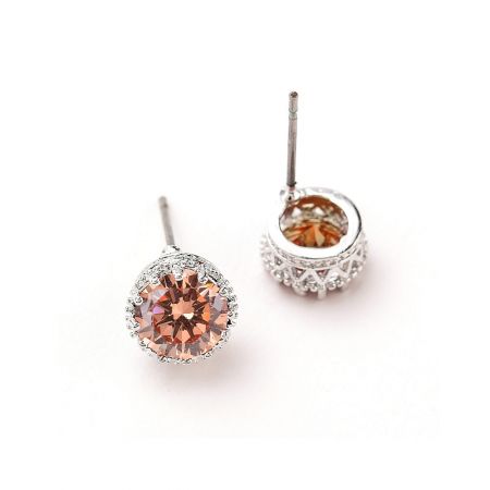 Close-up view of the Solitaire Stud Crown Earring showcasing the intricate silver setting with peach and clear cubic zirconia stones.