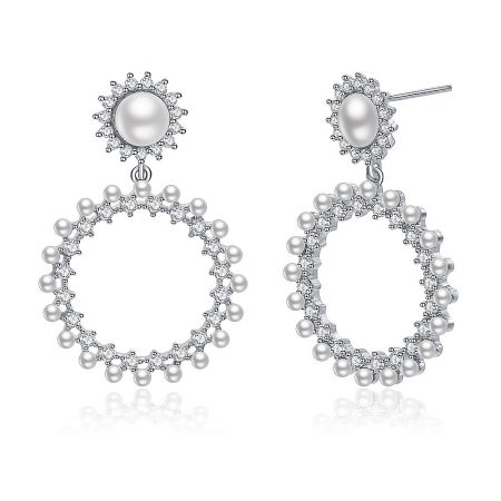 Detailed close-up of the Show Love earrings, highlighting the intricate arrangement of pearls and clear stones.