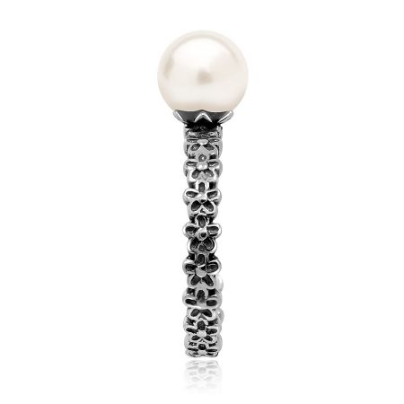 Detailed shot of the Elegant Beauty Pearl Ring against a decorative background.