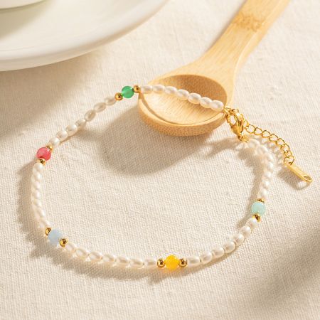 Detailed view of the pearl and colorful glass bead anklet.