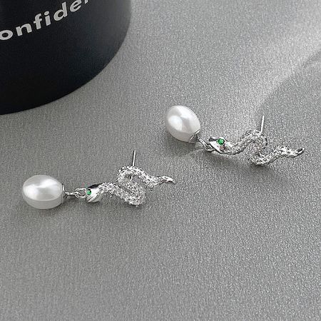 Angled view of the pearl and crystal snake earrings, showcasing their intricate design.