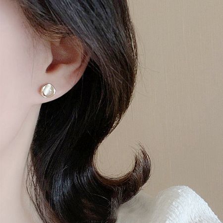 A model showcasing the elegant cat-eye stone stud earring, highlighting its size and fit.