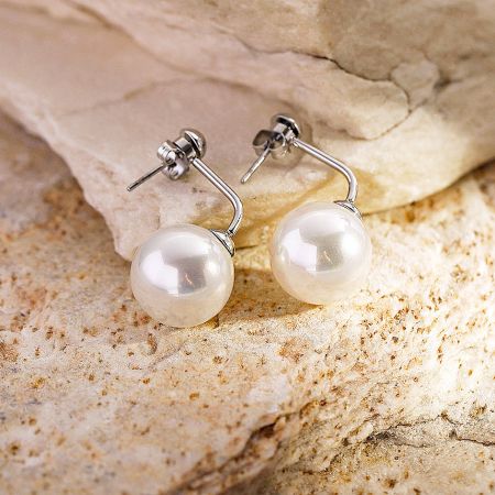Side view of the pearl stud earrings showcasing the silver posts.