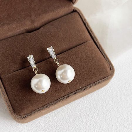 French Fashion Simple Pearl Pierced Drop Earrings (5 Pairs) - A pair of French fashion simple pearl drop earrings with clear stones, elegantly displayed in a brown jewelry box.