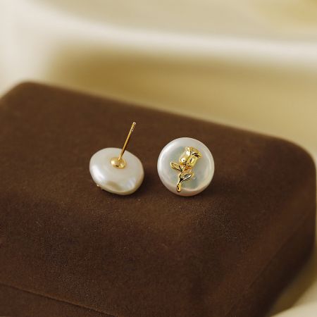 Baroque Pearls with Gold Flower Stud Earrings (5 pairs) - A pair of Baroque pearl stud earrings with a delicate gold flower design, elegantly displayed on a brown velvet stand.