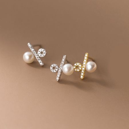 A collection of three different pearl earring designs, highlighting the intricate metalwork and stone details in both silver and gold finishes.