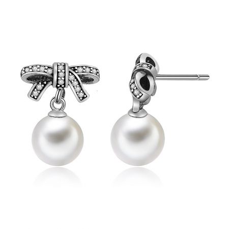Detailed view of the bow pearl drop stud earring showing the intricate silver bow and the secure post closure.