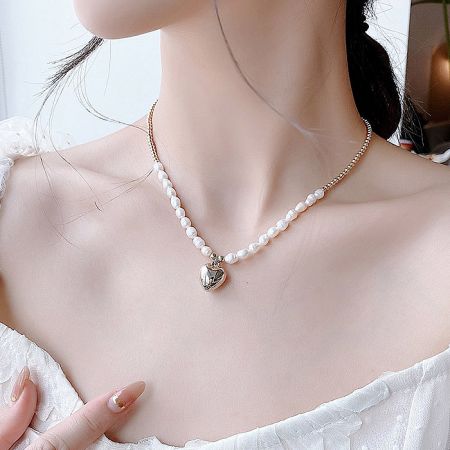 Angled shot of the Valentine pearl necklace showcasing its shine.