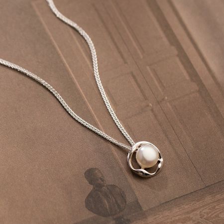 Another perspective of the elegant pearl pendant on the 925 silver chain.