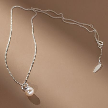 Elegant shot of the 925 sterling silver pearl necklace against a soft background, highlighting its delicate chain.