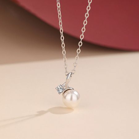 Detailed view of the sterling silver pearl and cubic zirconia necklace, showing the clasp and pendant.