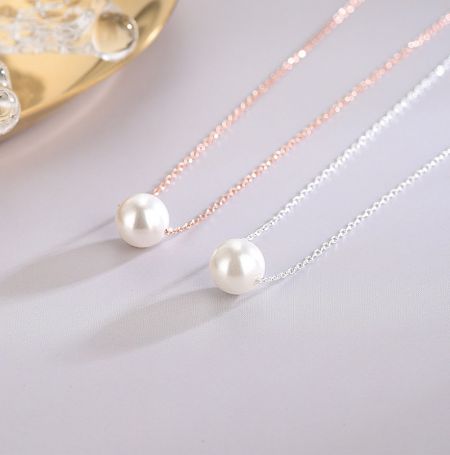 925 Sterling Silver Shell Pearl Necklace - A pair of 925 Sterling Silver Shell Pearl Necklaces, one plated in rose gold and the other in silver, showcasing the elegant design and lustrous pearls.