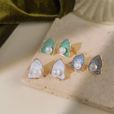 Three pairs of scallop pearl stud earrings in green, white, and gray enamel finishes.