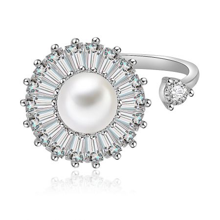 Elegant pearl ring with a halo of baguette-cut diamonds.
