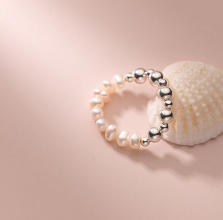 925 Sterling Silver Fresh Water Pearl Elastic Bead Ring - A close-up view of the 925 Sterling Silver Fresh Water Pearl Elastic Bead Ring, showcasing its lustrous pearls and silver bead details.