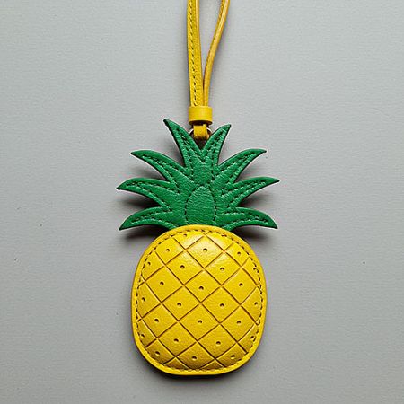 A detailed pineapple-shaped leather charm, perfect as a bag accessory or pendant.