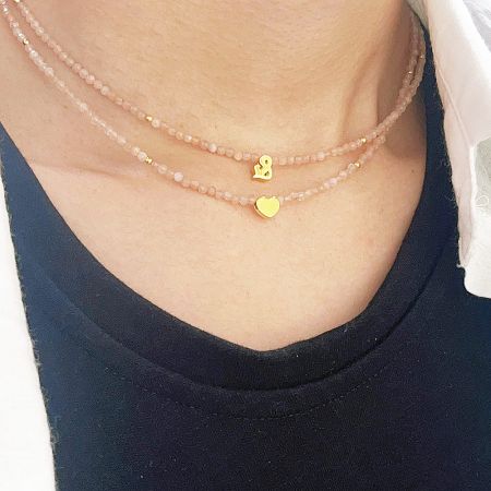 Two layered pink beaded necklaces with sterling silver charms.