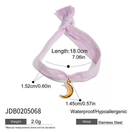 Detailed shot of the lavender ribbon bracelet featuring a gold crescent moon charm, made from durable stainless steel.