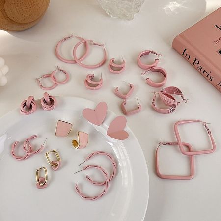 Assortment of pink enamel earrings showcasing different designs and styles.