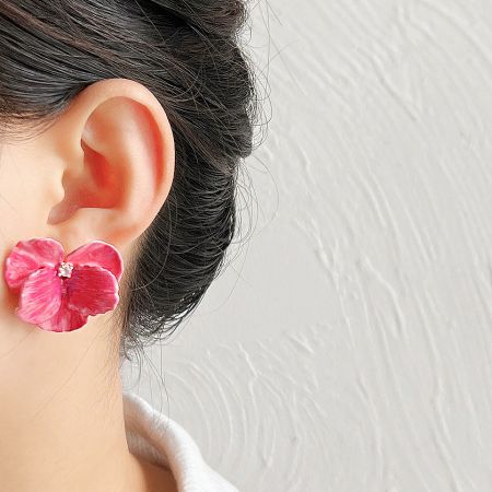 Model showcasing the elegant enamel flower earring.
