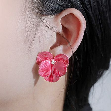 Close-up view of the 3D petal flower earring being worn.
