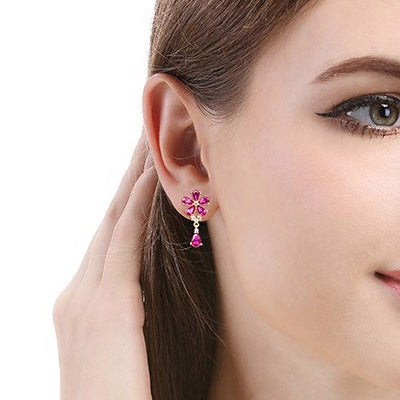 Model wearing the elegant pink flower drop earring to demonstrate its size and style.
