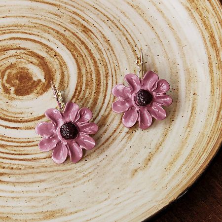 A pair of pink enamel 3D flower earrings with gold French hooks against a white background.