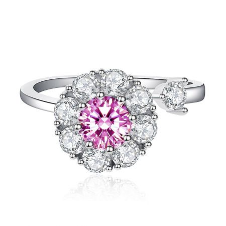 Pinky Flower Spinning Ring - A close-up of the Pinky Flower Spinning Ring, showcasing its central pink cubic zirconia surrounded by a halo of white gemstones on a rhodium-plated band.