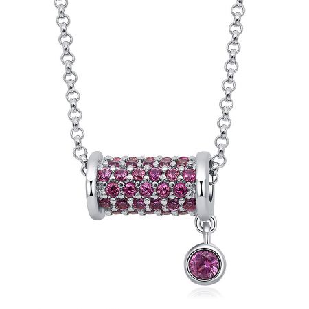 Close-up of the pink gemstone-encrusted cylindrical pendant with a dangling gemstone.