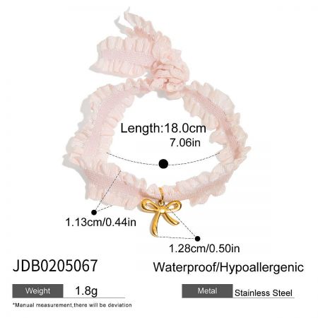 Close-up of the pink ruffle ribbon bracelet with a delicate gold bow charm, highlighting its coquette style.