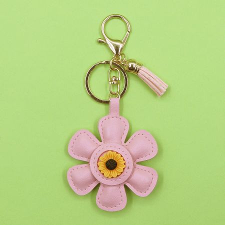 Close-up of the pink PU leather sunflower keychain with a matching tassel.