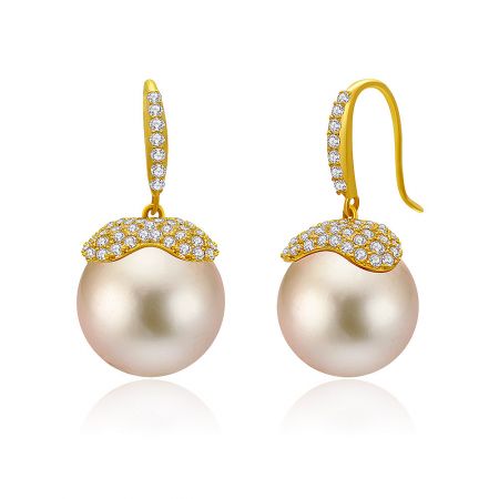 Detailed view of the pink pearl drop earrings highlighting the intricate gold caps and hooks with diamond accents.